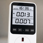Close-up of the LCD screen showing live wattage, voltage and running cost