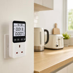 Smart Energy Monitor Plug installed on a kitchen wall socket next to a kettle and toaster